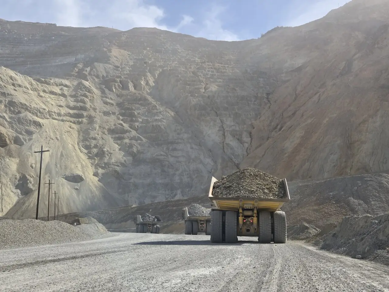 Loaded haul truck climbing a haul road inside an open pit